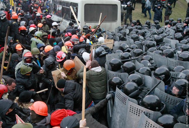 Pro-European protesters clash with Ukranian riot police during a rally near government administration buildings in Kiev